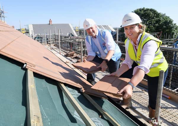 Chris Jones (emh) and Eleanor Deeley (Deeley Group) pictured at the 'topping out' ceremony at The Willows development in Asfordby EMN-210710-155500001