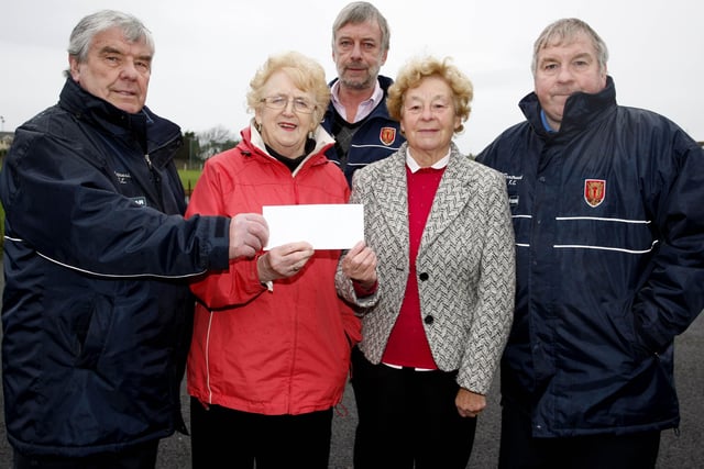 HOSPICE SCORES...Margaret McCullagh and Eileen Caldwell of Portrush Hospice Support Group receive a cheque, which was raised during the Portrush FC School of Soccer, from committee members Moore Peacock, Ken Fillis and Dessie Stewart. CR47-241PL