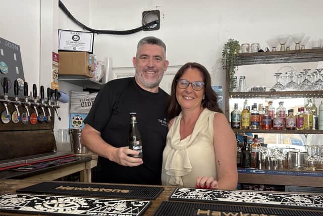 Jim Godwin and Lisa Bunting behind the bar at The Hop Stop in Melton Mowbray
