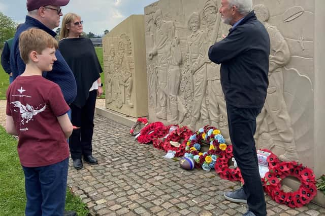 FOTT chair, Alec Wilson, explains the scenes engraved on the Burrough memorial to Laura Briggs, her husband Lowell and son Liam