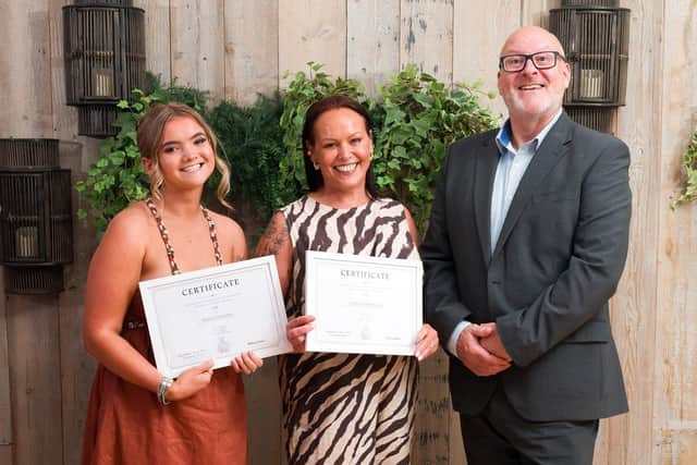 Lucie Larke (centre) picks up cheques for Melton Learning Hub and Helping The Isolated