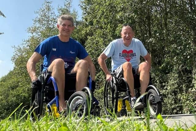 Dan and Stuart in training in their wheelchairs on a country road ahead of Sunday's Great North Run