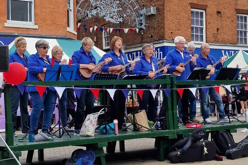 Members of Melstrum Ukulele Orchestra entertaining audiences in Melton Market Place