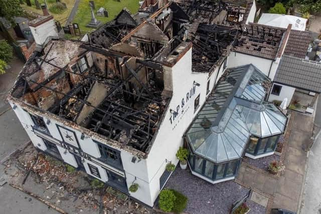 The burned out shell of the Tap and Run after the blaze last June