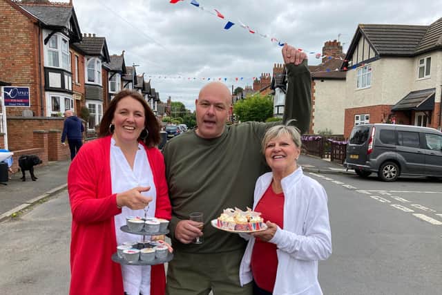 Craven Street residents Amanda, Yvonne and Dave enjoy a street party for the Platinum Jubilee