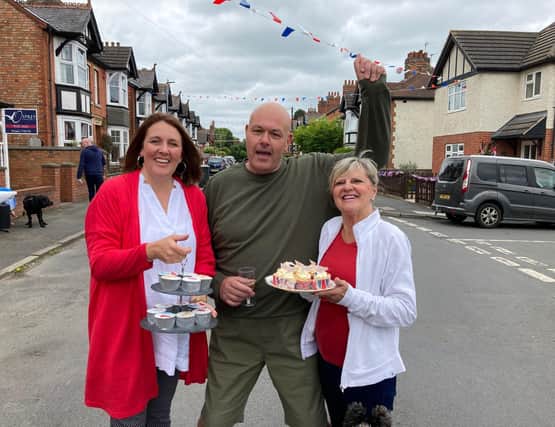 Craven Street residents Amanda, Yvonne and Dave enjoy a street party for the Platinum Jubilee