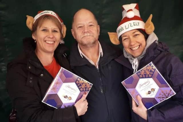 Christmas elves Shelagh Core (left) and Nikki Kirk offering their wrapping service to Melton shopper Alun Hodges back in December 2018