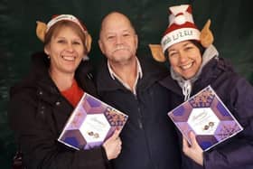 Christmas elves Shelagh Core (left) and Nikki Kirk offering their wrapping service to Melton shopper Alun Hodges back in December 2018