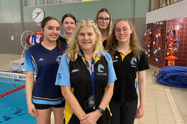 Melton Swimming Club coach Tracy McGhie with some of the club's talented young swimmers