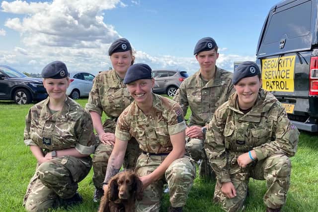 Private Kira Fitzpatrick and Cocoa with other military personnel and cadets at Saturday's open day at Melton's Defence Animal Training Regiment