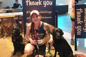 Amanda Woodford with her London Marathon medal and guide dogs