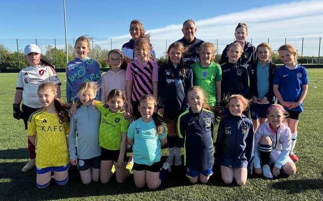 Some of the players take a break from an Asfordby Amateurs Ladies Girls & Inclusive FC training session at John Ferneley College's 3G pitch