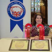 Megan Cawthorne, a baker at Melton Mowbray's Ye Olde Pork Pie Shoppe, poses with the three awards the company won at this year's British Pie Awards, at St Mary's Church PHOTO Martin Elliott