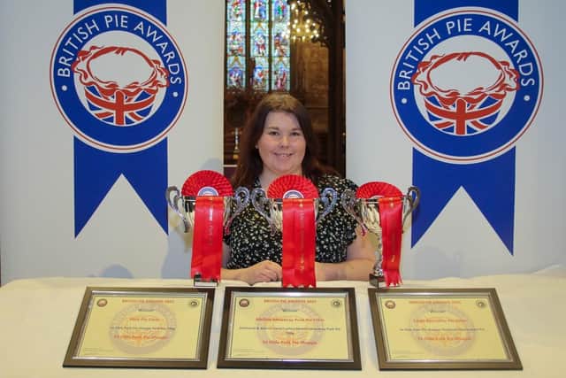 Megan Cawthorne, a baker at Melton Mowbray's Ye Olde Pork Pie Shoppe, poses with the three awards the company won at this year's British Pie Awards, at St Mary's Church PHOTO Martin Elliott