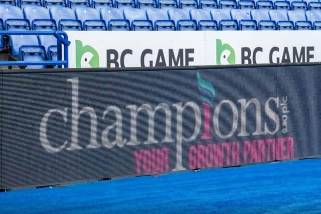 Pitchside branding displaying Champions UK plc's logo at the King Power Stadium