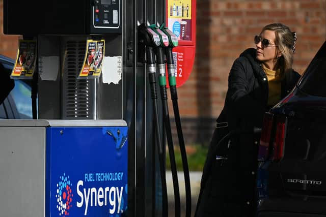 A motorist refuels a vehicle with diesel fuel at an Esso petrol station in Lutterworth, Leicestershire (Photo by Oli SCARFF / AFP via Getty Images)