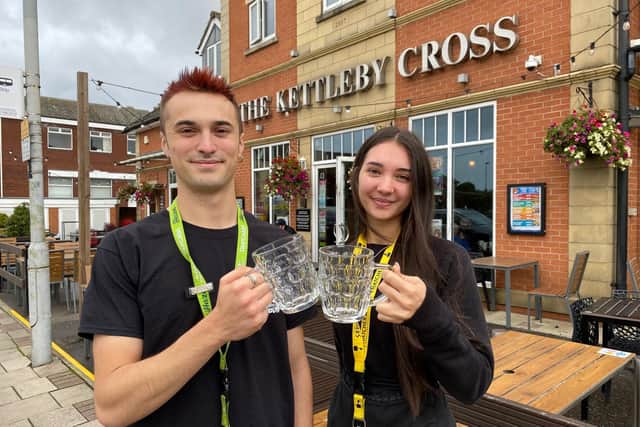 Bar staff at The Kettleby Cross celebrate the Melton pub being included in the latest edition of the Good Beer Guide