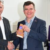 John Reddington receiving the Platinum Business Club trophy from Alex Lochrane, CEO at Canine Partne