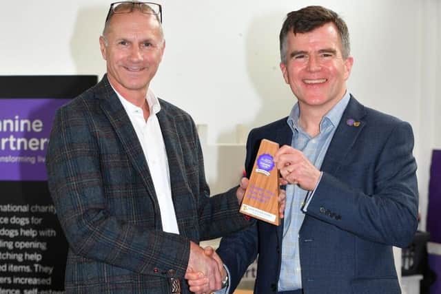 John Reddington receiving the Platinum Business Club trophy from Alex Lochrane, CEO at Canine Partne
