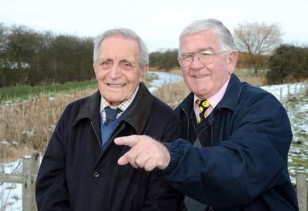 At the wartime Lancaster bomber crash site in 2013, Dennis Kirk (left) recalls the incident for Barrie Davies (right) who is the son of the only crash survivor Sgt Douglas Davies