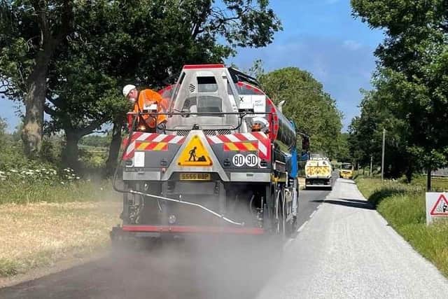 A Leicestershire County Council's highways team carries out summer maintenance on a local road