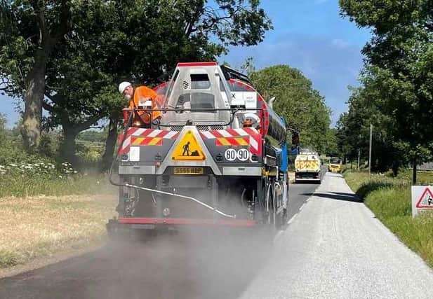 A Leicestershire County Council's highways team carries out summer maintenance on a local road