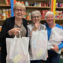 Storehouse manager Siggy Atherton (left) with some of the volunteers holding food bags