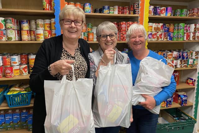 Storehouse manager Siggy Atherton (left) with some of the volunteers holding food bags