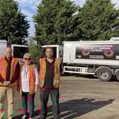 Deputy Melton Borough Council leader, Margaret Glancy, with members of the local bin collection team and lorries with the new signage on