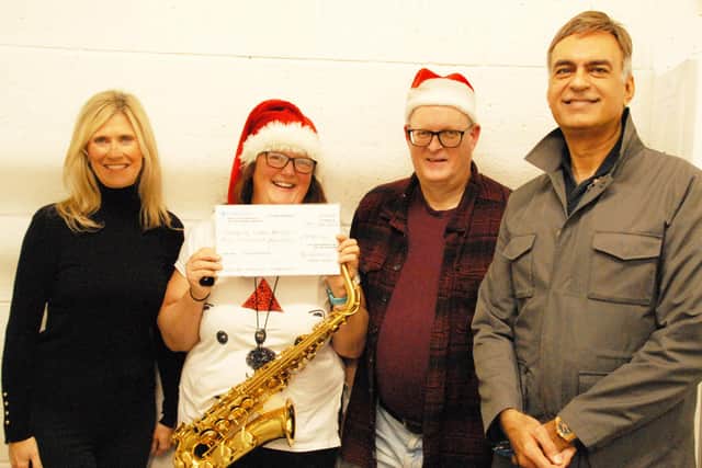 Belvoir Big Band presents a cheque to the ‘Healing Little Hearts’ charity, from left, Lesley Mistry MBE (charity's lead nurse and trustee), Jo Saywell (nurse and alto sax player), Allan Toombs (band secretary) and Dr Sanjiv Nichani OBE