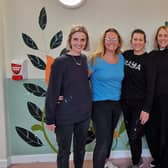 Five of the six artists pictured with some of their artwork on the walls of Melton's St Mary's Birth Centre