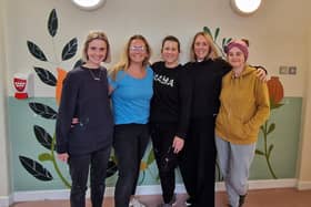 Five of the six artists pictured with some of their artwork on the walls of Melton's St Mary's Birth Centre