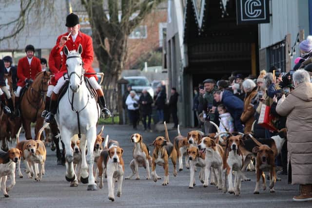 The hounds follow the sound of the horn as the Belvoir Hunt meets at Melton market