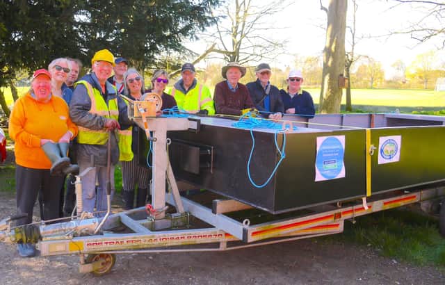 Melton and Oakham Waterways Society volunteers on their new workboat
