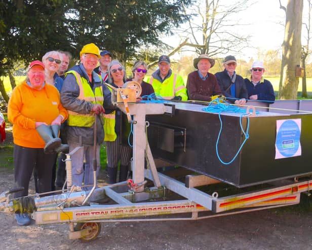 Melton and Oakham Waterways Society volunteers on their new workboat