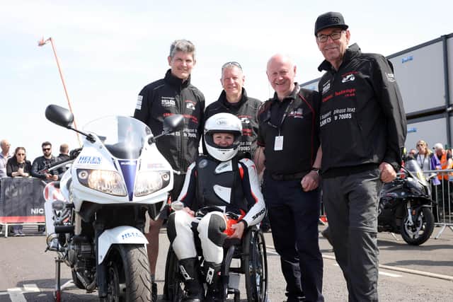 Claire Lomas in the NW200 pit lane with crew and husband, Dan