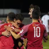 Henry Eze (left) celebrates one of Melton's goals against Wisbech last week, the first of three wins on the bounce. Pic: Mark Woolterton.