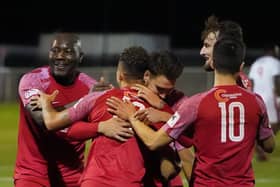 Henry Eze (left) celebrates one of Melton's goals against Wisbech last week, the first of three wins on the bounce. Pic: Mark Woolterton.