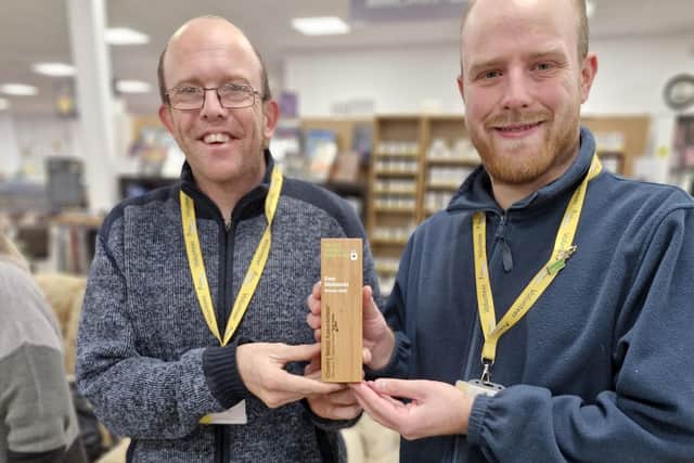 Staff at Melton's The Hanger celebrate with the trophy for UK's favourite charity shop