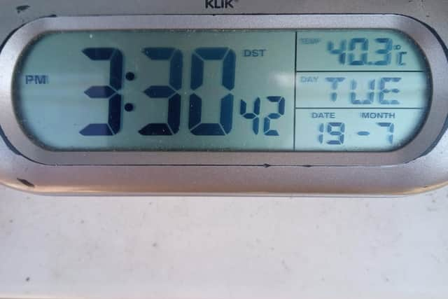 Matthew O'Callaghan shows off the thermometer reading at his Asfordby Road home this afternoon