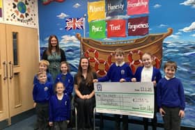 Whissendine Primary School pupils present their fundraising cheque to the Matt Hampson Foundation