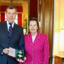 Charles Richards, with wife Serena, shows off his KVCO medal after the ceremony at Sandringham