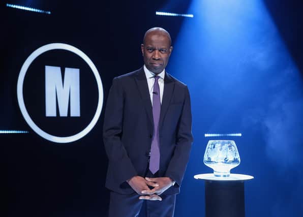 Host Clive Myrie with Mastermind trophy