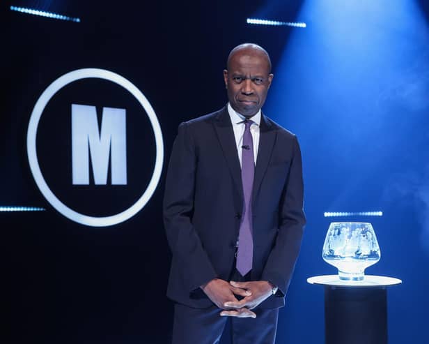 Host Clive Myrie with Mastermind trophy