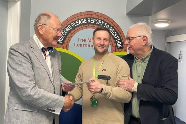 David Alcraft (Lodge Charity Steward) presents a cheque to Liam Weekes (Melton Learning Hub deputy operations manager) with Paul Mabbutt, also from the Lodge, looking on