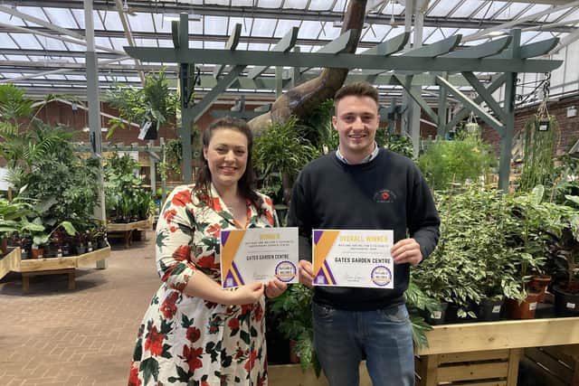 Jack Gates, the fourth generation of the family to run Gates Garden Centre, receives the award for being voted the area's top independent business from Rutland and Melton MP Alicia Kearns