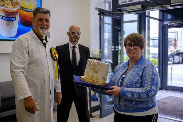 Greggs CEO, Roisin Currie, takes delivery of an 8kg wheel of Stilton from Clawson Farms’ master cheesemaker, Richard Mayfield IMAGE Jason Bye