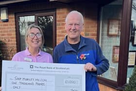 Karen Olivant, Barchester Charitable Foundation, presents Shopmobility Melton Mowbray coordinator Glyn Birch with a cheque