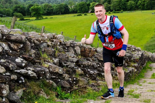 Anthony Ison running along Hadrian's Wall during the ultra marathon, The Wall