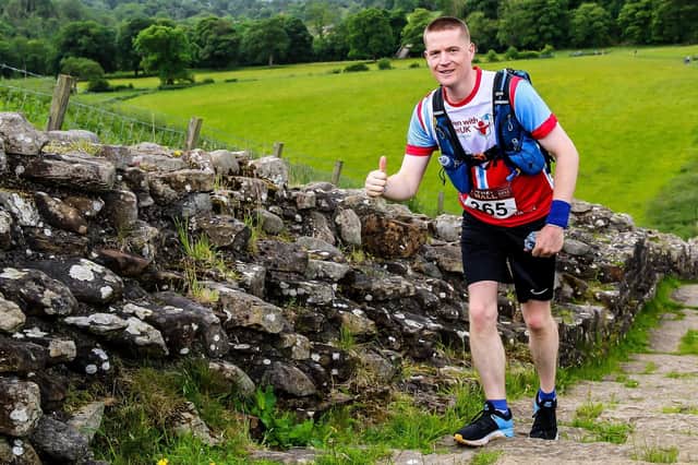 Anthony Ison running along Hadrian's Wall during the ultra marathon, The Wall